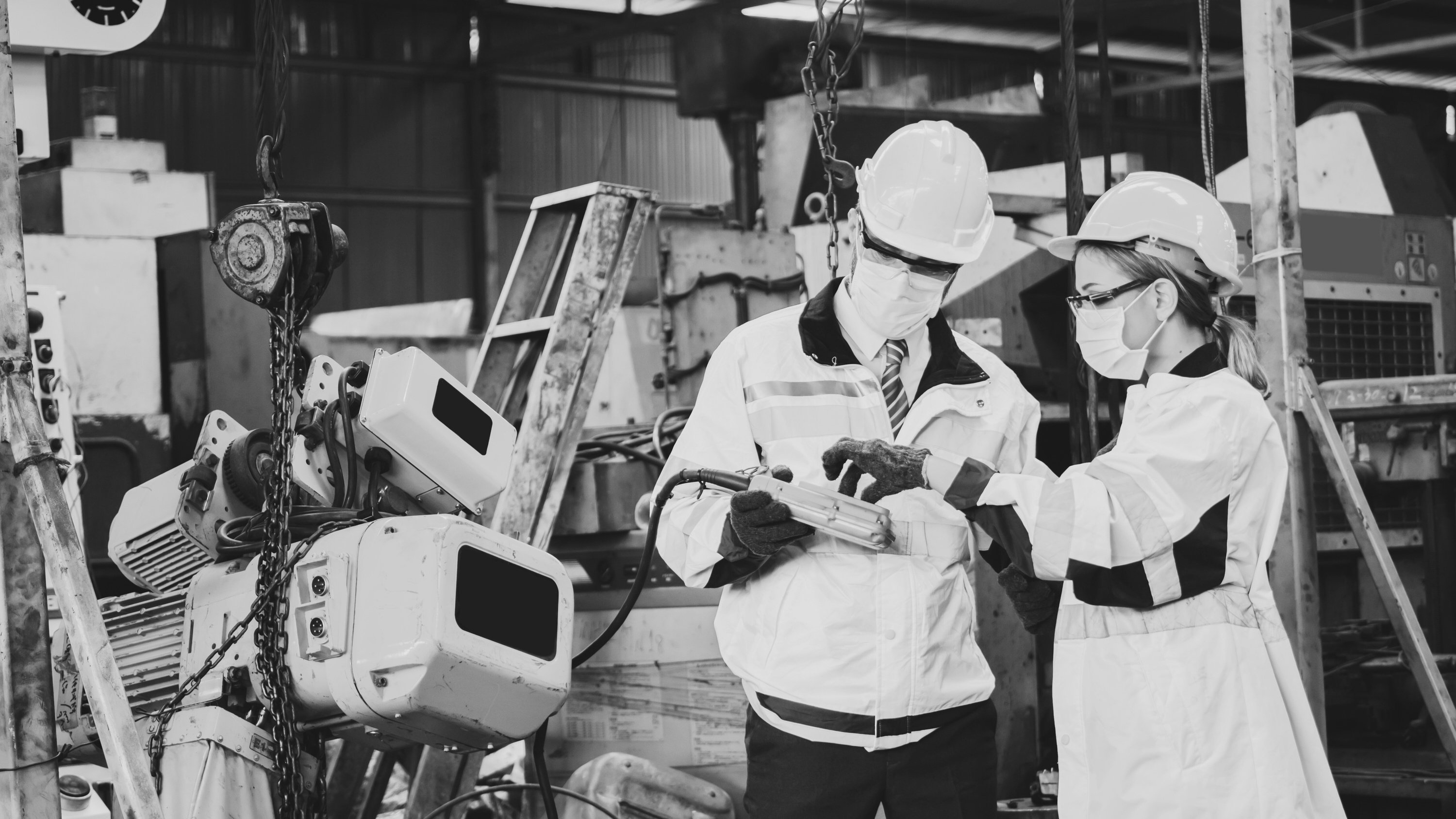 Industrial Engineer in Suite and Safety Helmet Working in Factor