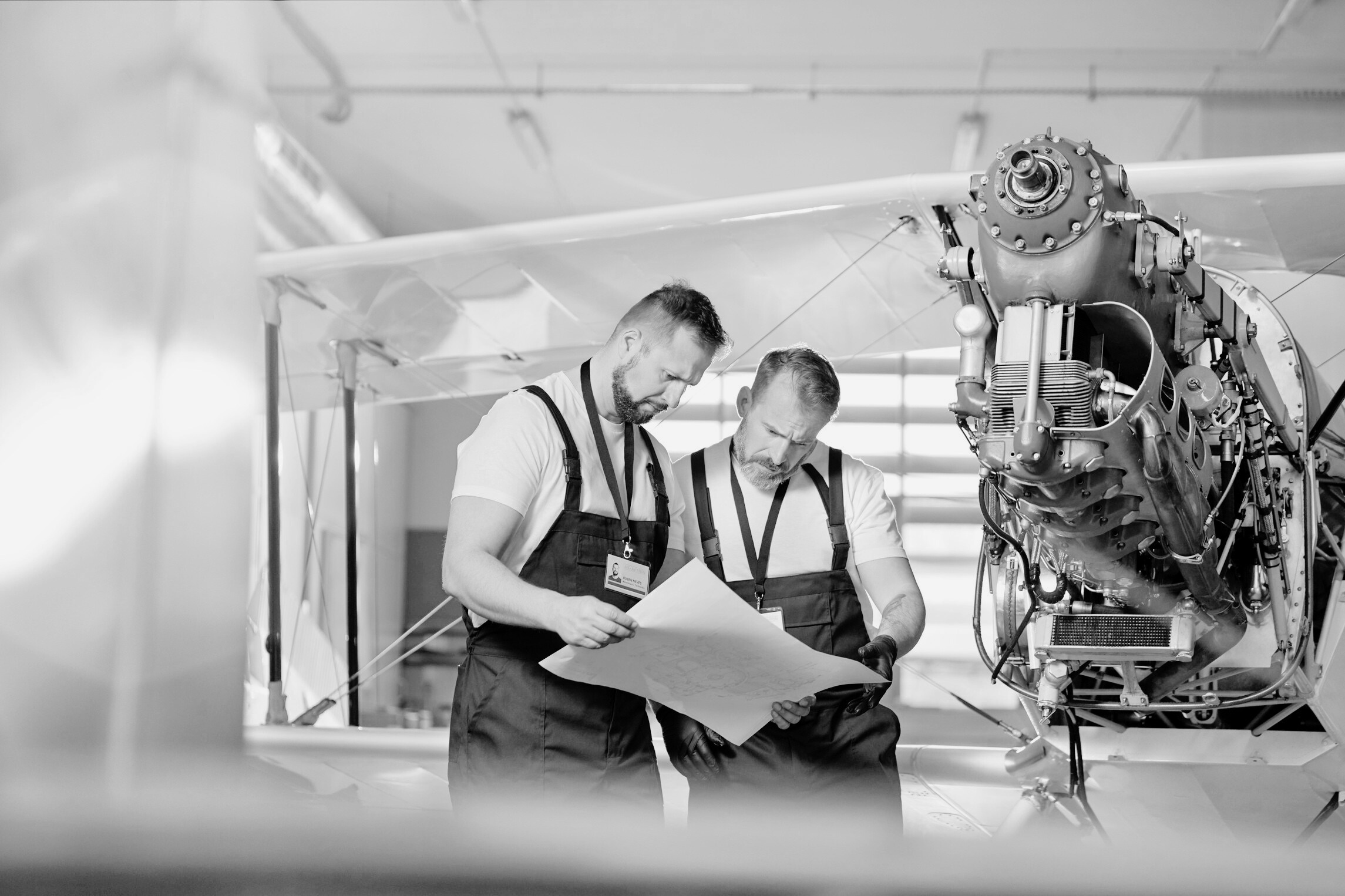 "Male engineer mechanics examining plans